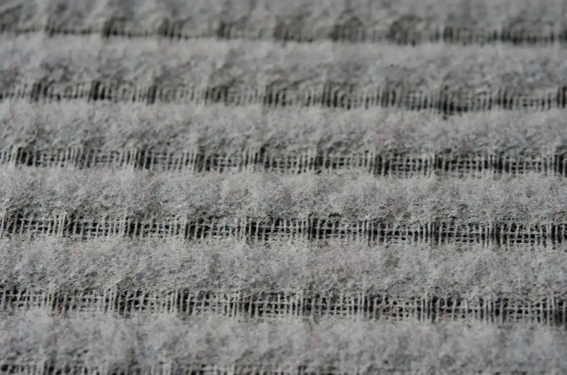 Close-up texture of a heavily clogged HVAC furnace filter covered in thick dust before an ac repair brownsville tx duct cleaning service.