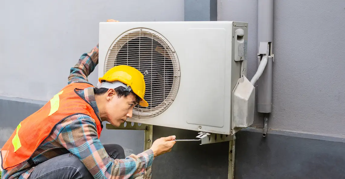 HVAC technician performing professional AC repair in Brownsville TX on an outdoor mini-split air conditioning unit.